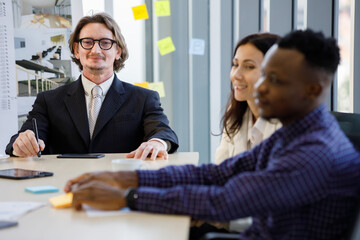 A man caucasian leadership smilling and african american In meetings about plans business at the meeting room in the office. Concept man manager leader.