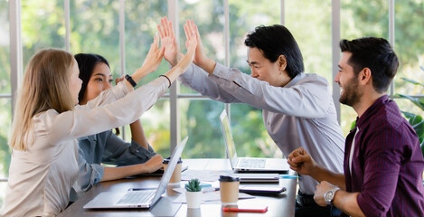 Group of diverse businesspeople, caucasian and asian, touching hands during the meeting  together...