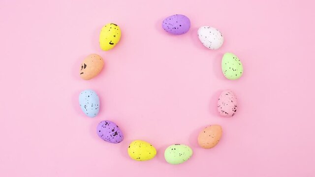 Easter eggs and feathers make circle with place for text. Stop motion