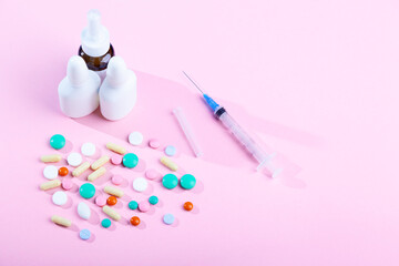 Medical medicines, spray, bottles of nose drops, syrup, vitamins, scattered tablets, capsules