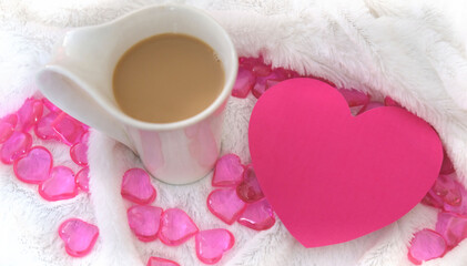 Greeting card  in shape heart with place for text. blurred cozy  still life with cup of coffee and plaid. Details of cozy bedroom,  morning for a loved one