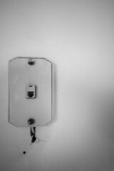 Vintage phone jack wall mount on a white wall