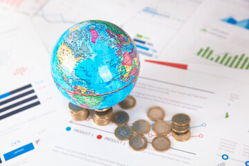 Euro coins and the earth on financial charts