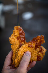 Fried chicken tenders drizzled with sauce