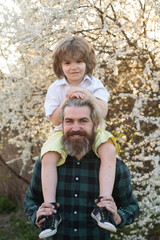 Fathers Day. Dad kid relationships. Child shoulder ride on dad. Son shoulder ride. Friendly family.
