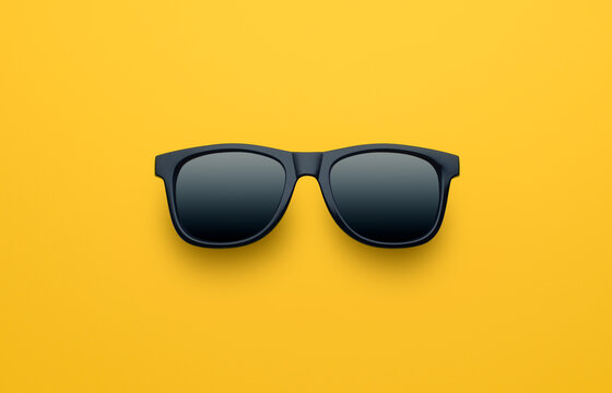 Black sunglasses on yellow background
