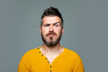 Obraz premium Barbershop. Serious Bearded man. Emotional portrait isolated on gray.