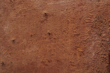 Multicolored background:rusty metal surface with peeling and cracking brown paint Natural defects Scratches,cracks,crevices,chips,dust,roughness,abrasion.Template for design and background.Copy space