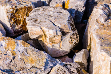 close up detail of rock surface with variety of colors under natural sunlight