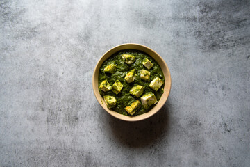 Top view of Palak paneer or cottage cheese cubes in spinach curry with use of selective focus 