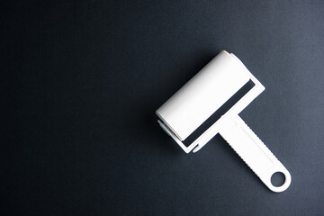 Fototapeta premium Roller Dust Collector on black background.Home cleaning concept, far from COVID-19