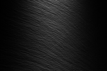 textured black slate background with spot of light