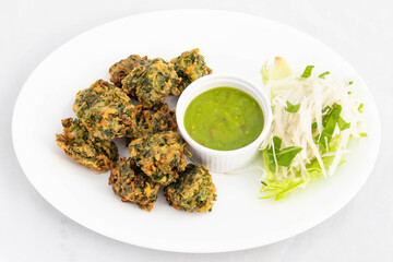 Indian Fritters Chaat Snacks Palak Pakoda Bhajji Chat Or Paalak Pakora Bajji Bhajiya Made Of Chopped Spinach Dhaniya Pudina Leaves And Gram Dal Flour Besan Masala Daal Served With Chutney Sauce