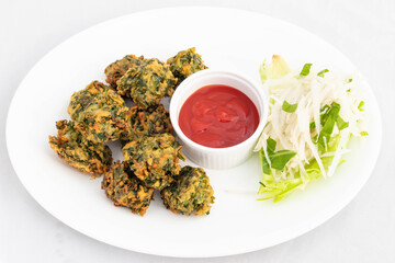 Indian Fritters Chaat Snacks Palak Pakoda Bhajji Chat Or Paalak Pakora Bajji Bhajiya Made Of Chopped Spinach Dhaniya Pudina Leaves And Gram Dal Flour Besan Masala Daal Served With Red Chutney Sauce