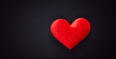 Red hearts placed on a vintage black steel background.