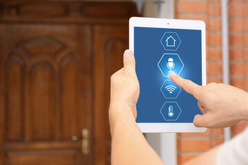 Man using application of smart home automation near house outdoors