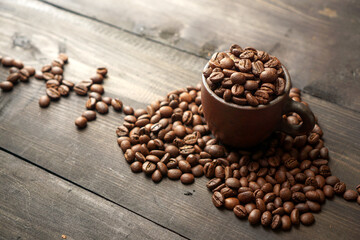 Coffee beans shape a love sign on the wooden table            