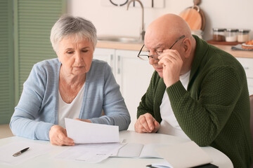 Stressed senior couple in debt at home