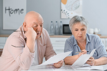 Stressed senior couple in debt at home