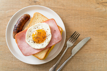 bread toasted cheese topped ham and fried egg with pork sausage