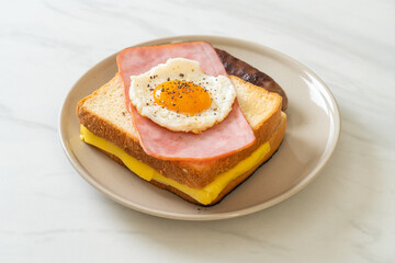 bread toasted cheese topped ham and fried egg with pork sausage