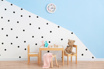 Interior of modern children's room with table and toys
