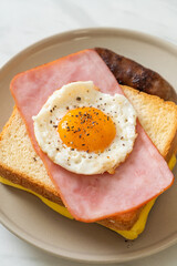 bread toasted cheese topped ham and fried egg with pork sausage