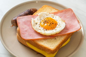 bread toasted cheese topped ham and fried egg with pork sausage