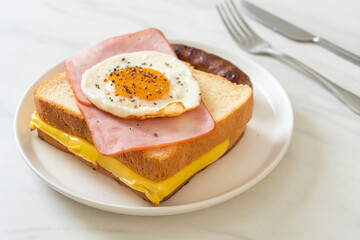 bread toasted cheese topped ham and fried egg with pork sausage