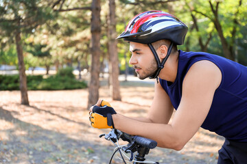 Male cyclist riding bicycle outdoors