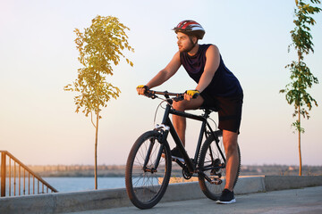 Male cyclist riding bicycle outdoors