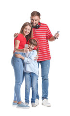 Happy family with mobile phones and headphones on white background