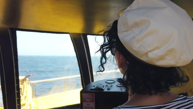 Attractive strong woman sailing with her yacht