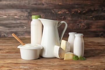 Different dairy products on wooden background