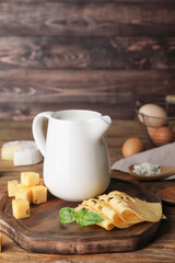 Different dairy products on wooden background