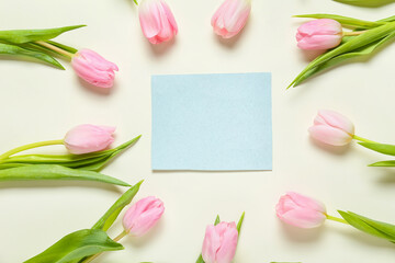 Beautiful flowers and empty card on white background