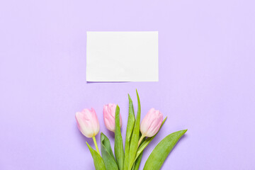 Beautiful flowers and empty card on color background