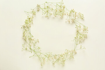 Frame made of beautiful flowers on light background