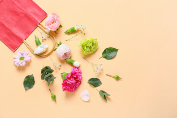 Beautiful composition with shopping bag and flowers on color background