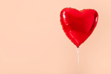 Heart shaped air balloon on color background