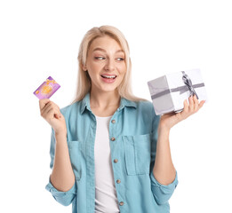 Beautiful young woman with gift card and present on white background