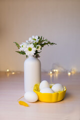 Vase with flowers and easter eggs with boken. Easter background