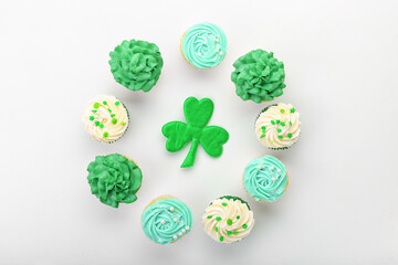 Tasty cupcakes for St. Patrick's Day on white background