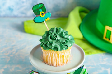 Tasty cupcake for St. Patrick's Day on color background