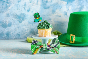 Tasty cupcake for St. Patrick's Day on color background
