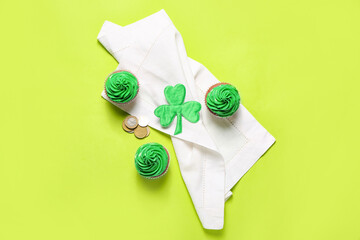 Tasty cupcakes for St. Patrick's Day on color background