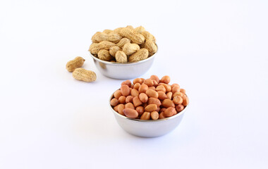 Healthy food peanuts and peanut pods in steel bowls.