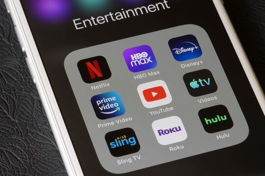 Portland, OR, USA - Feb 2, 2021: Assorted streaming apps are seen on an iPhone, including Netflix, HBO Max, Disney Plus, Amazon Prime Video, YouTube, Apple TV, Sling TV, Roku, and Hulu.