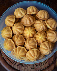 Kuih Bahulu, baulu or bolu in a container. Sponge cake baked in special aluminium moulds is the Asian tradition food in popular Malaysia and Indonesia.