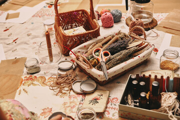 Hand made yellow candles from natural bee wax. Tdried grass and flowers are in the basket. Master class on creating candles